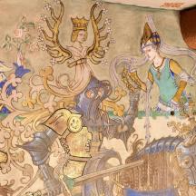 een schilderij aan de zijkant van een muur met leeuwen