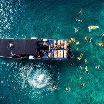 a boat in the water with a group of people