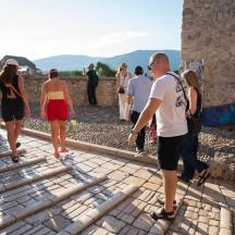 a group of people walking down a stone walkway