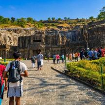 a group of people walking around the ruins of elephanta caves