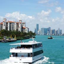 a boat in the water with a city in the background