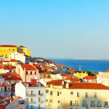 a view of a city with buildings and the ocean