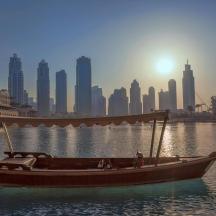 a boat in the water with a city in the background