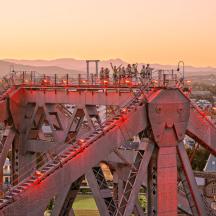 a red bridge with people standing on top of it