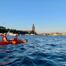 two people are riding in kayaks on the water