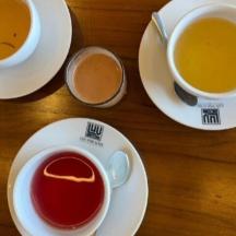 three cups of coffee sitting on a wooden table