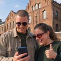 a man and a woman looking at a cell phone