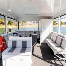 a white boat with two chairs and a table