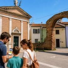a man and a woman and a child standing in front of a building