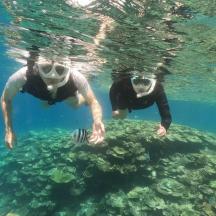 two people are swimming in the water