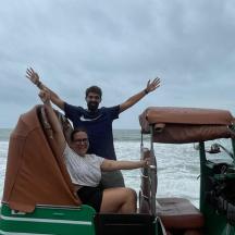 a man and a woman sitting in a golf cart