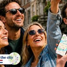 a group of people holding up a cell phone