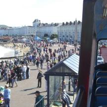 a large crowd of people walking on the beach