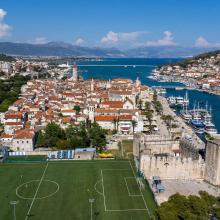 an aerial view of a city with a soccer field