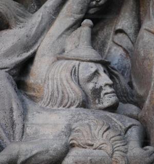 a stone statue of a woman on a wall