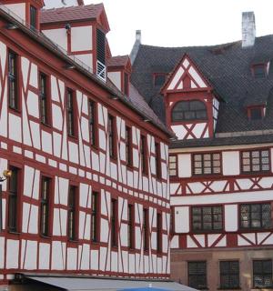 a large white and red building with a black roof