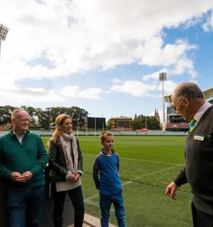 a group of people standing in front of a soccer field