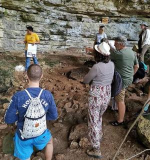 a group of people standing in a muddy cave