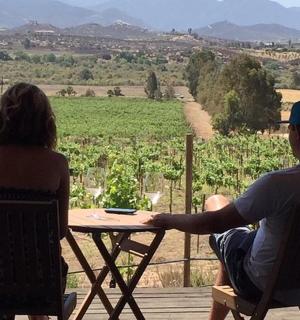 a man and a woman sitting at a table with a view