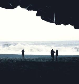 a group of people standing on a beach