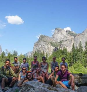 a group of people posing for a picture on some rocks