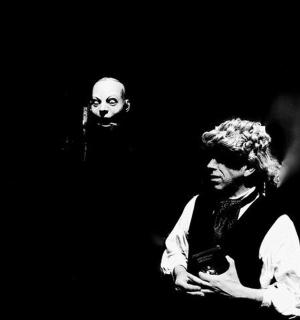 two men standing next to each other on a stage