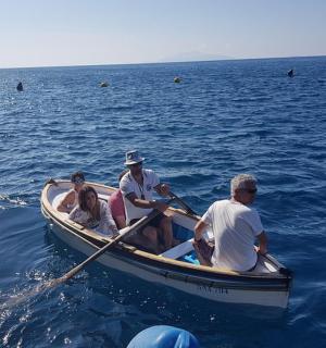 a group of people in a boat in the water