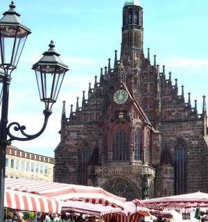 a large building with a clock tower in a city