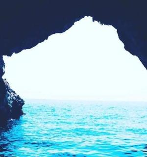 a view of the ocean from inside a cave