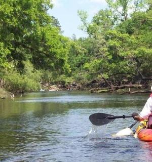a person in a kayak on a river