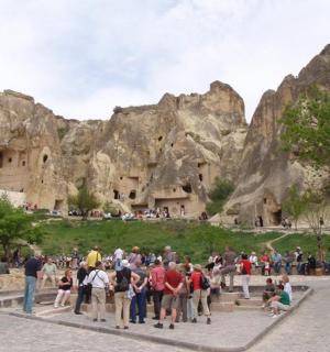 a group of people standing in front of a mountain