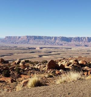a view of a desert with rocks and mountains