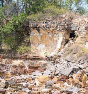 a rocky mountain with a cave in the side of it