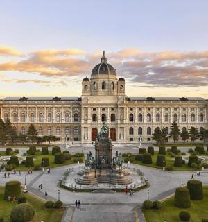 a large building with a fountain in front of it