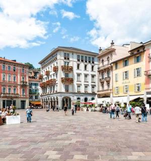 a group of people walking around a city street