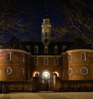 a large building with a clock tower at night