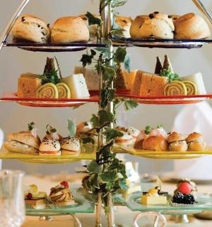 a three tiered display of pastries and breads on a table