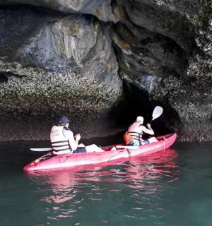 two people in a red kayak in a cave