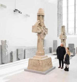 a woman and child looking at a sculpture in an art museum