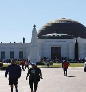 a group of people walking in front of a building