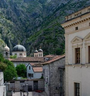 a building with domes and a mountain in the background