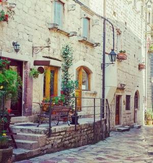 an alley with a bench in an old building