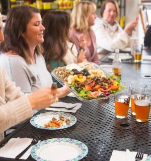 一群妇女坐在桌边吃饭