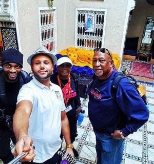a group of people standing in front of a house