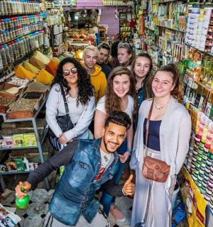 a group of people standing in a store aisle
