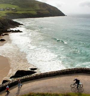 a person riding a bike on the beach