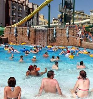 a group of people in a pool at a water park