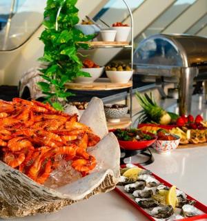 a buffet with shrimp and other food on a table
