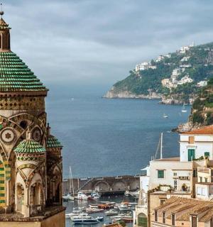 a building with a green roof on top of a city