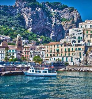 a boat in a body of water next to buildings